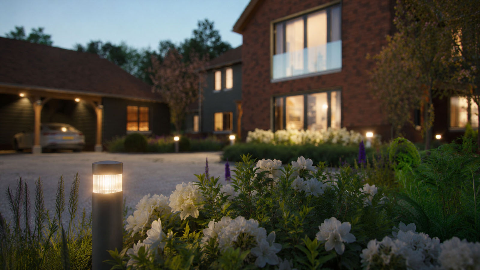 Garden lighting and planting by the driveway at dusk